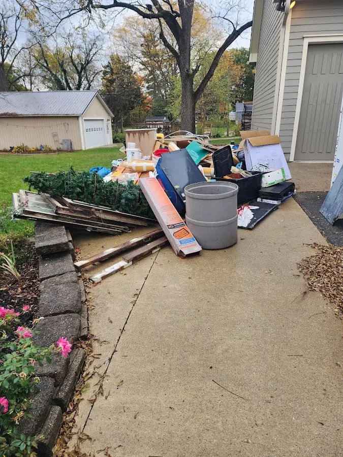 Dumpster being loaded with debris for 10 Yard Dumpster Rental in Springfield